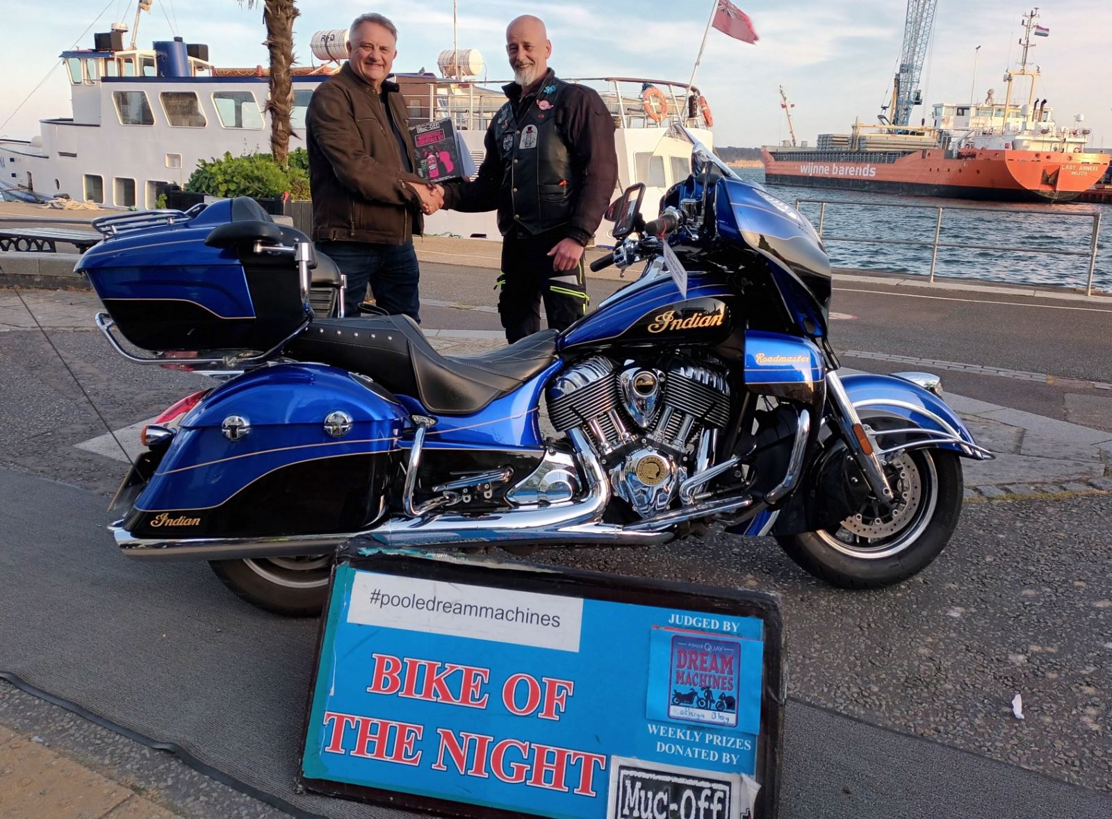 Men shaking hands after winner bike of the night at Poole quay